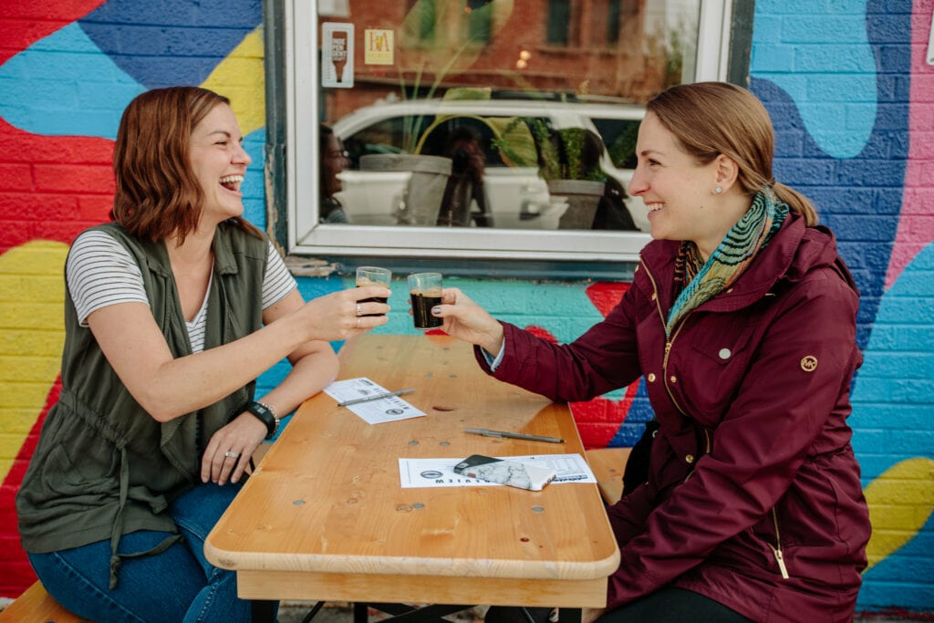 Two women enjoying beer on the RiNo Beer and Graffiti Tour in Denver, Colorado