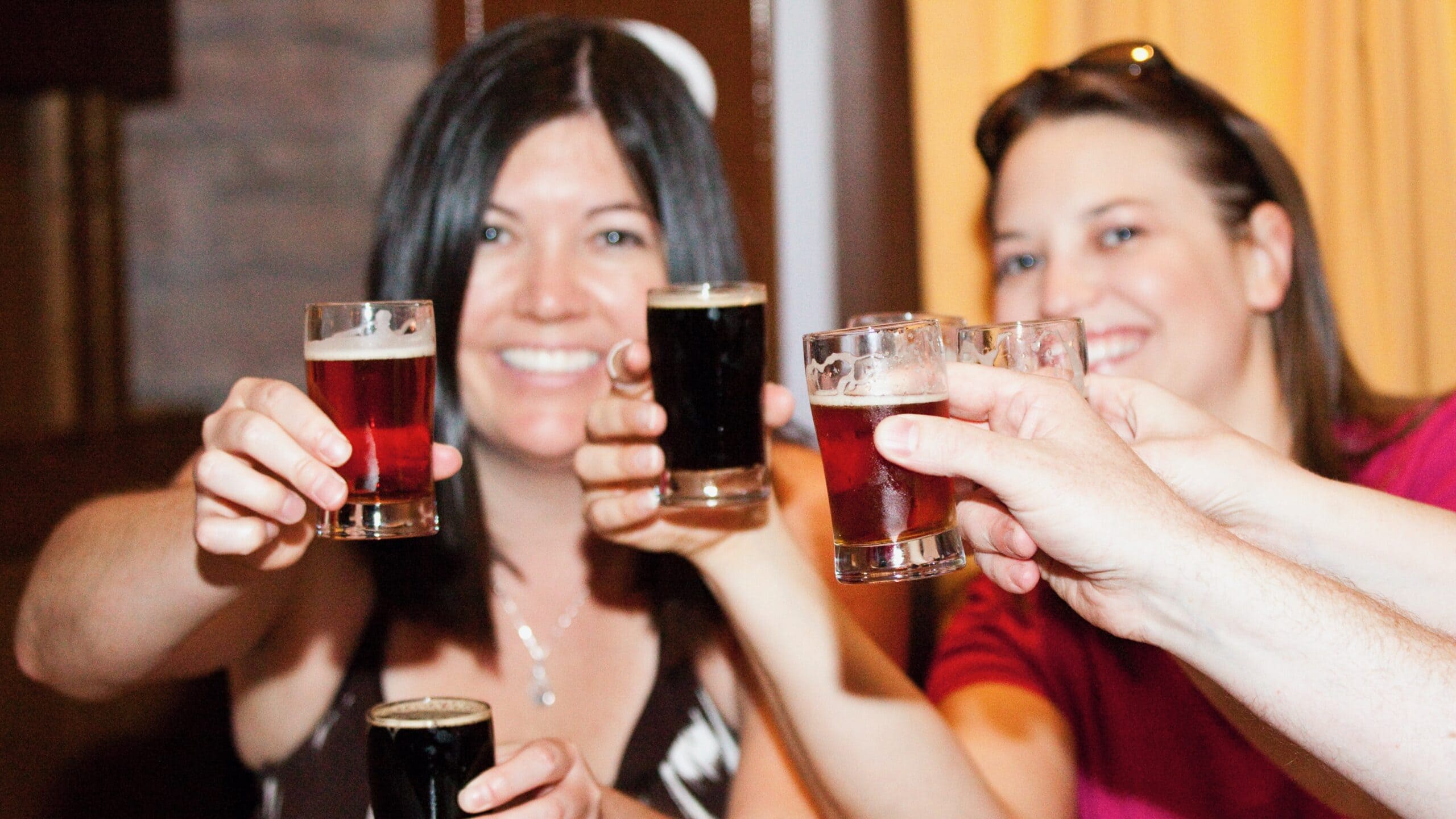 3 friends cheersing on the LoDo Craft Beer Tour