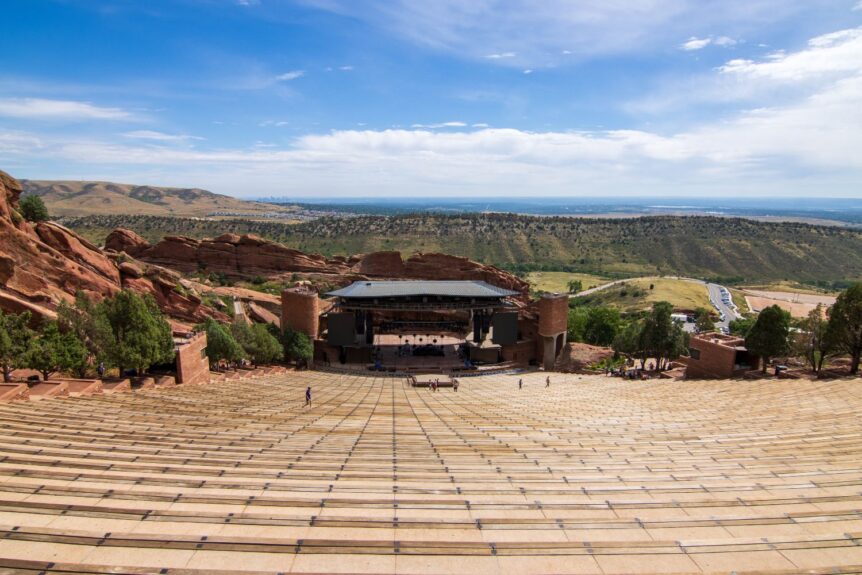 Scenic view of Red Rocks Amphitheatre with red sandstone formations and tiered seating under a blue sky